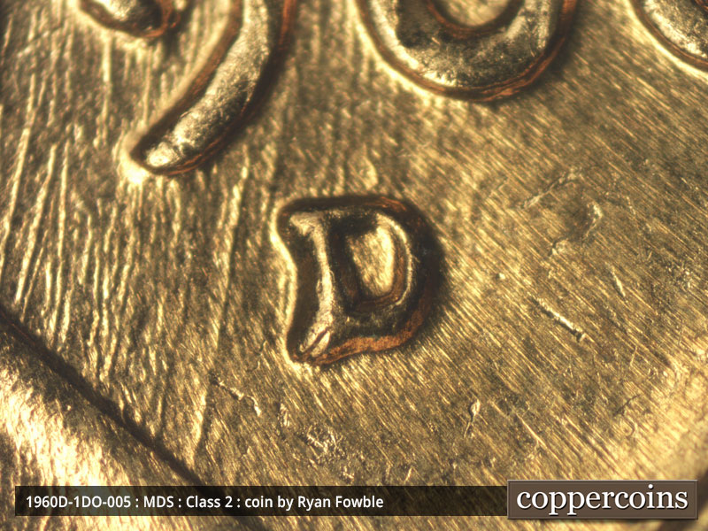 Die-stage C marker on 1960D•1DO•005 showing Heavy N-S die scratches show in area around date.