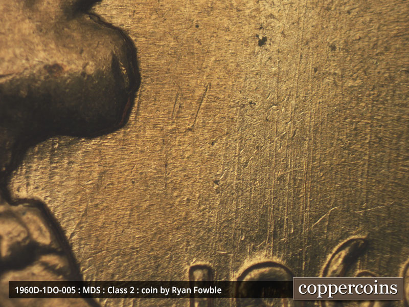 Die-stage C marker on 1960D•1DO•005 showing N/S die scratches through and above date.