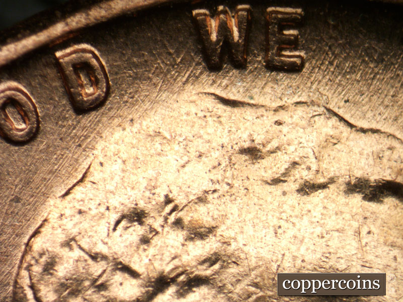 Die-stage B marker on 1960D•1DO•007 showing NE die scratches through GOD WE.