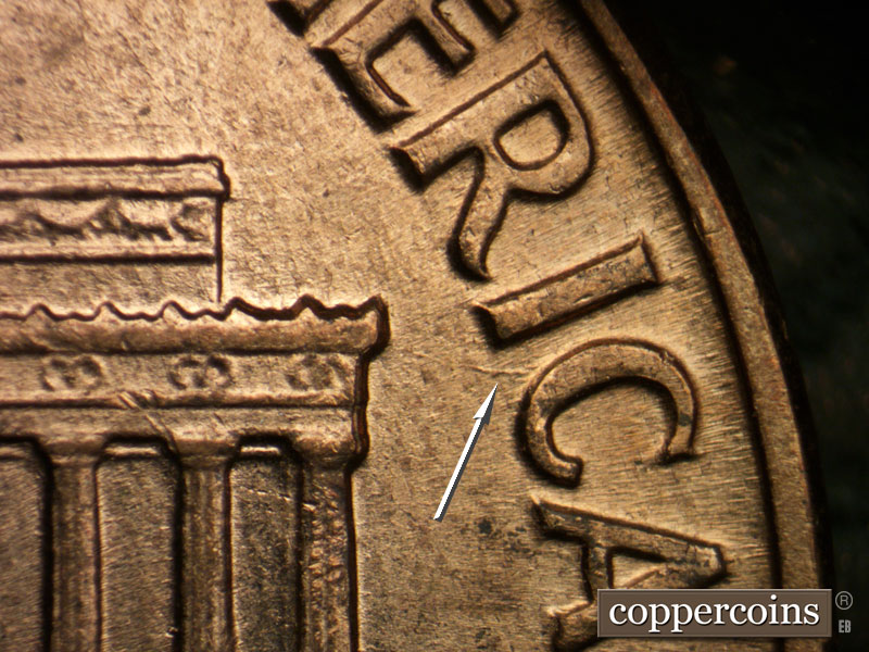 Die-stage B marker on 1960D•1DO•007 showing Die gouge between IC in AMERICA.