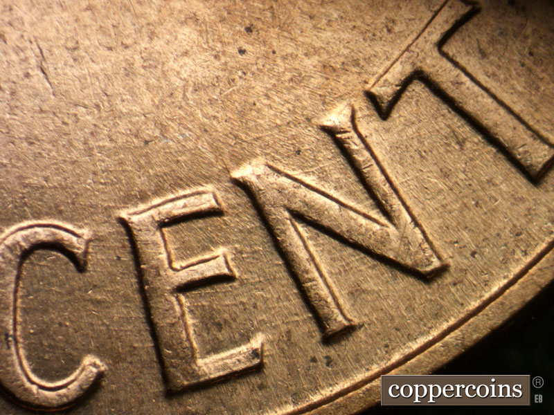 Die-stage B marker on 1960D•1DO•007 showing Concentric die scratches through ONE CENT.