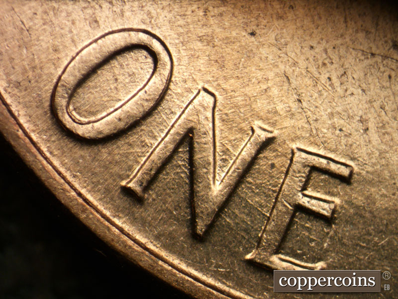 Die-stage B marker on 1960D•1DO•007 showing Concentric die scratches through ONE CENT.