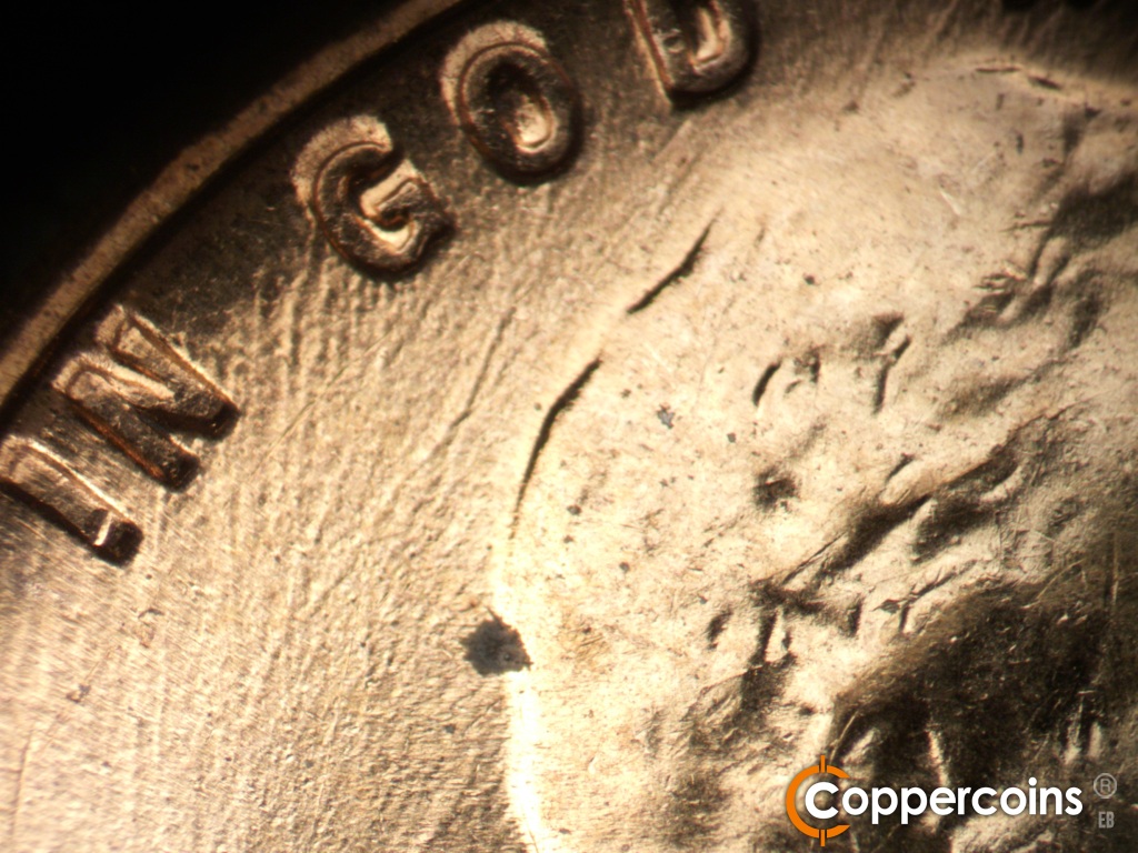 Die-stage C marker on 1960D•1DO•007 showing Worn die scratches under GoD.