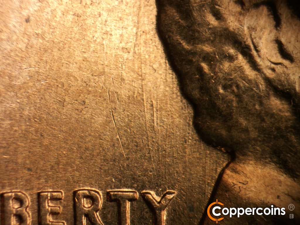 Die-stage B marker on 1960D•1DO•008 showing Curved die scratch from top of Y in LIBERTY behind head.