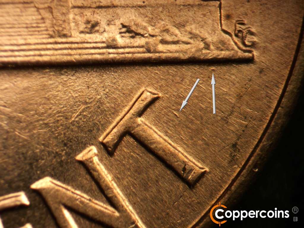Die-stage B marker on 1960D•1DO•008 showing Die dot under base. Die gouge near T in CENT.
