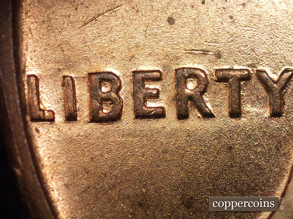 Die-stage A marker on 1960D•1MM•001 showing A die scratch connects the top of the I to the top of the B of LIBERTY.