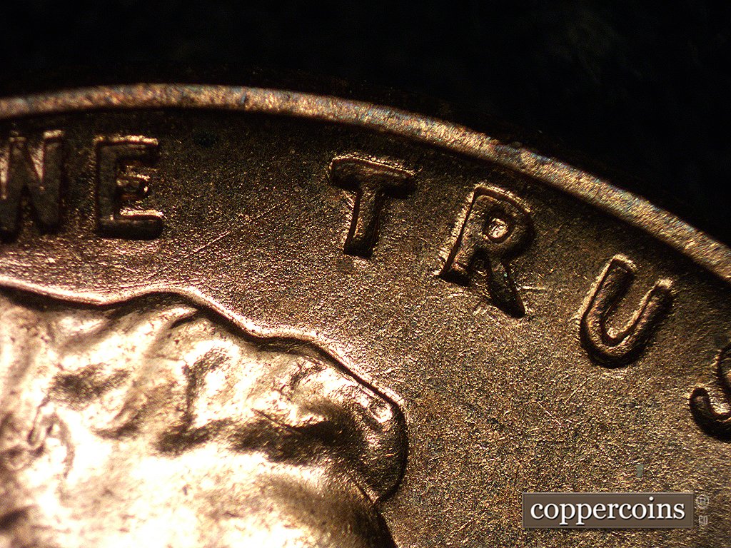 Die-stage A marker on 1960D•1MM•001 showing Sharp die scratches run diagonally through T and R of TRUST.