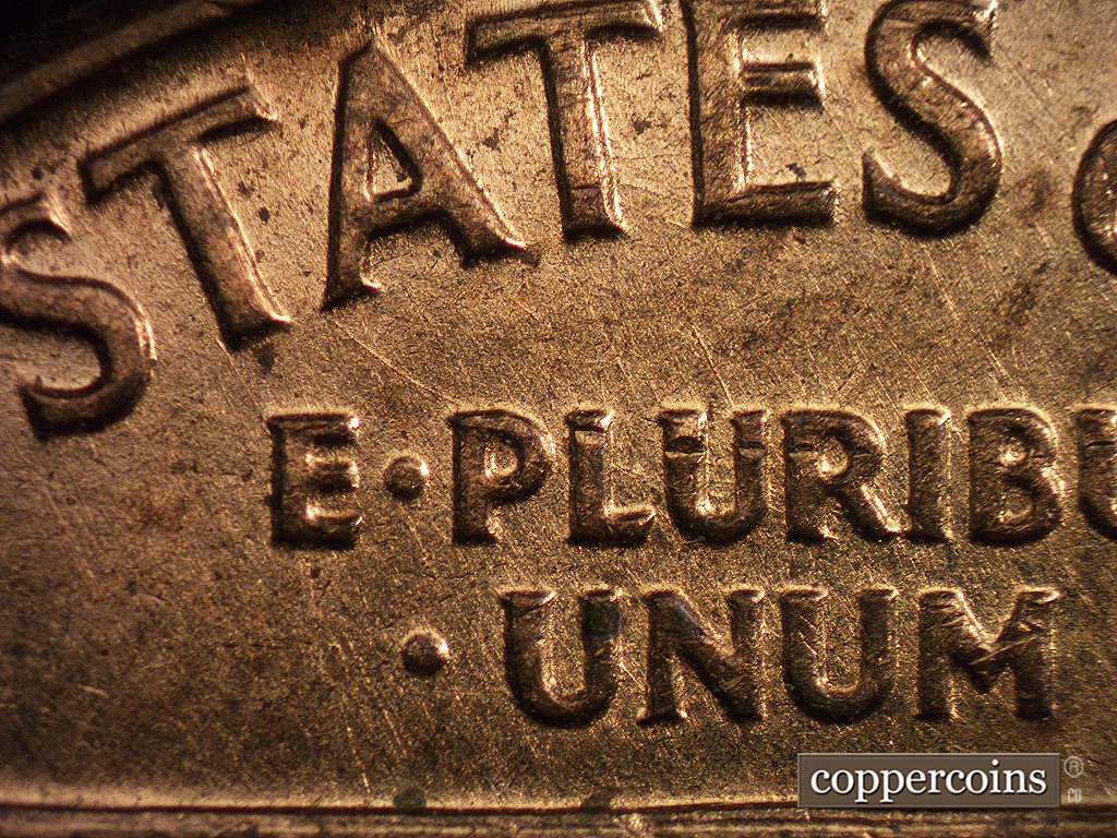 Die-stage A marker on 1960D•1MM•001 showing Die scratches run NE through the Motto. Of note is another die scratch that runs SE from the lower left corner of the….