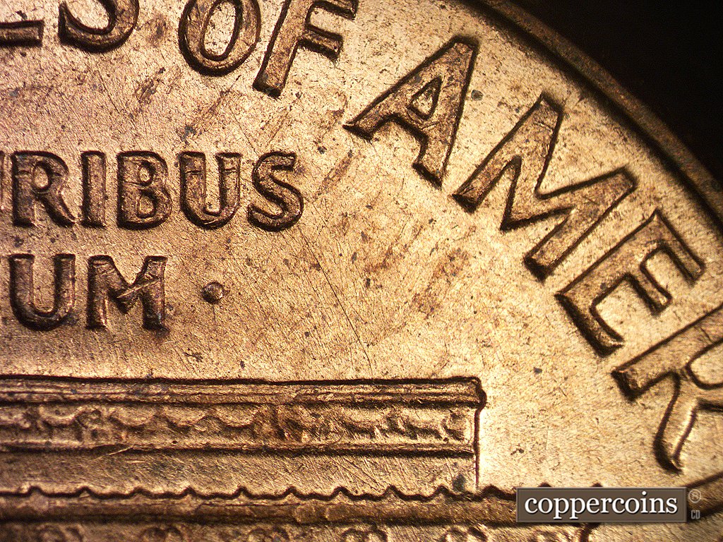Die-stage A marker on 1960D•1MM•001 showing Die scratch from the O in OF through the S of the PLURIBUS to the right roof area.