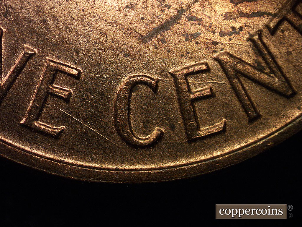 Die-stage A marker on 1960D•1MM•001 showing Large die scratches near the bottom of the design through the denomination.