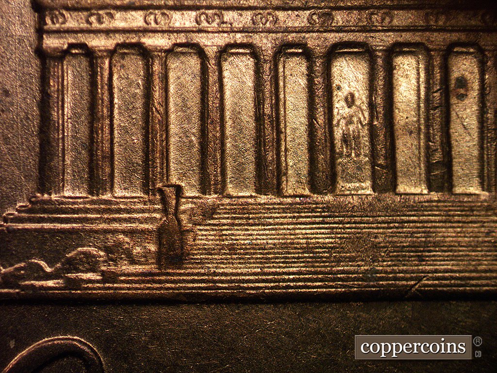 Die-stage A marker on 1960D•1MM•001 showing Light die scratches show through the bays, especially in bay #6 above the statue. A long N-S die scratch shows just t….