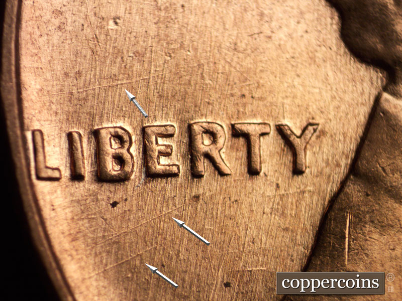 Die-stage B marker on 1960D•1MM•001 showing Intersecting die scratches through LIBERTY.