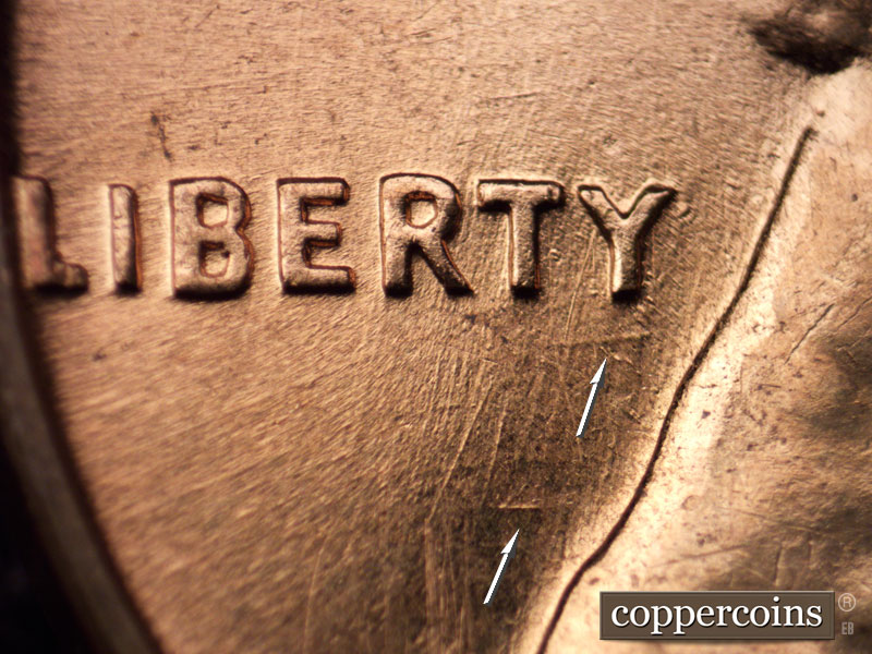 Die-stage C marker on 1960D•1MM•001 showing Intersecting die scratch through RTY in LIBERTY, Heavy E/W die scratch under Y in LIBERTY.