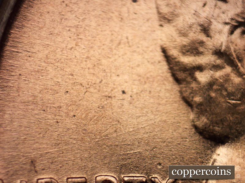 Die-stage C marker on 1960D•1MM•001 showing Die scratches above LIBERTY.