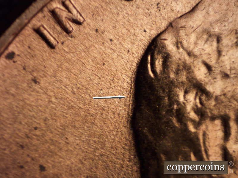 Die-stage B marker on 1960D•1MM•002 showing Die scratch behind head.