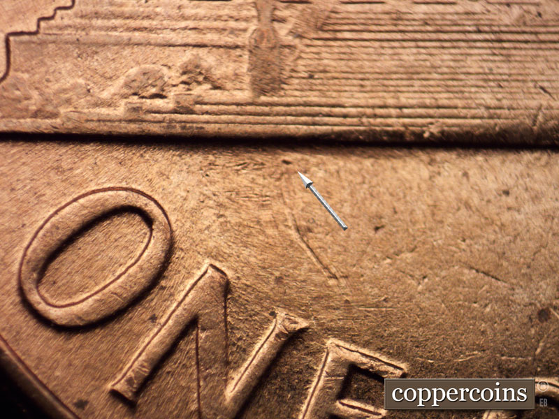 Die-stage B marker on 1960D•1MM•002 showing Die dot below base.