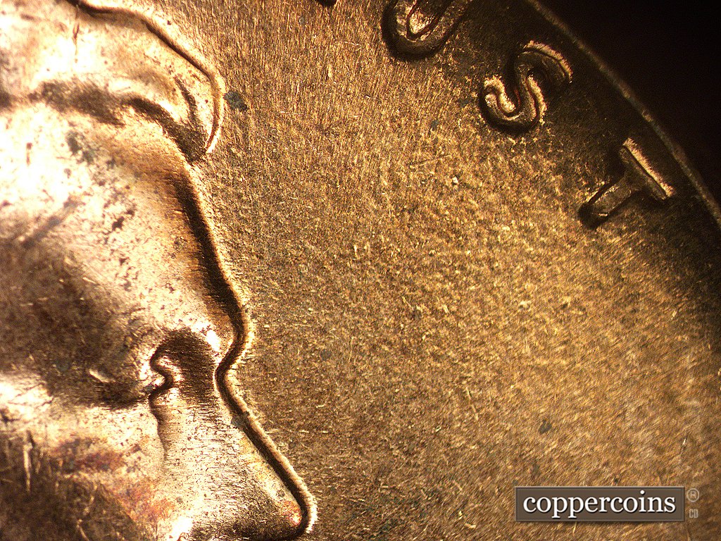Die-stage C marker on 1960D•1MM•002 showing N-S die scratches on and around the face are visible but very worn.