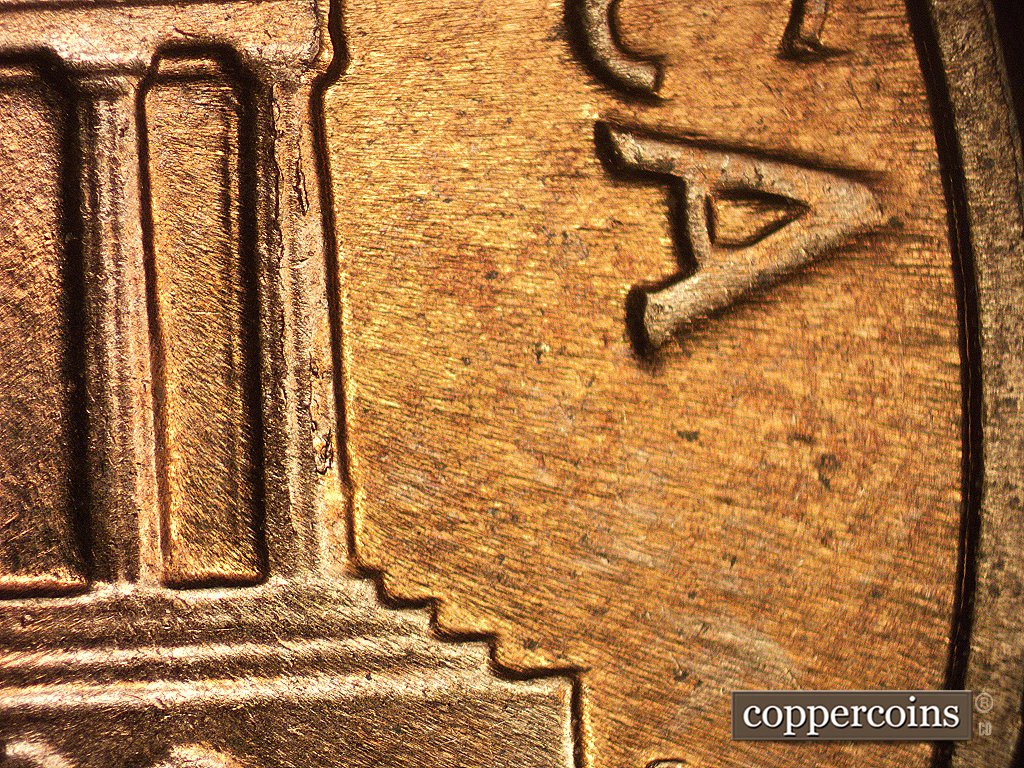 Die-stage C marker on 1960D•1MM•002 showing Die cracks show on column 12.