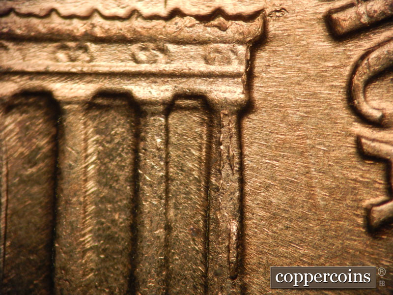 Die-stage D marker on 1960D•1MM•002 showing Die chipping on column 12.