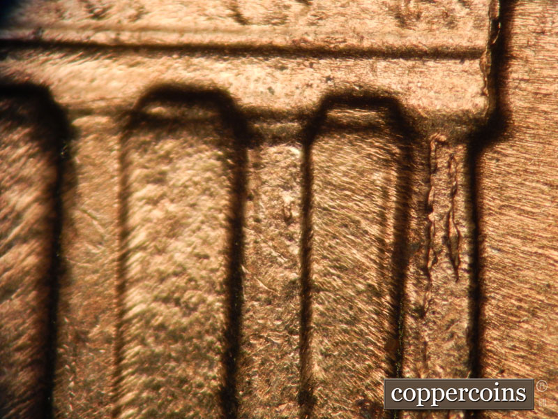 Die-stage D marker on 1960D•1MM•002 showing Die chipping on column 12.