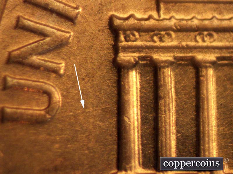 Die-stage B marker on 1960D•1MM•003 showing WSW die scratch from column 1 to the U of UNITED.
