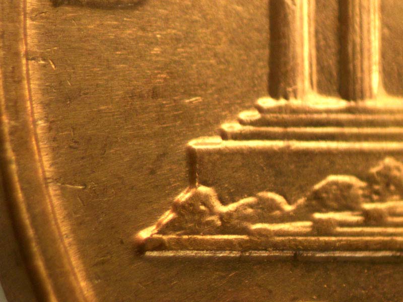 Die-stage B marker on 1960D•1MM•003 showing Short die gouge above left base.