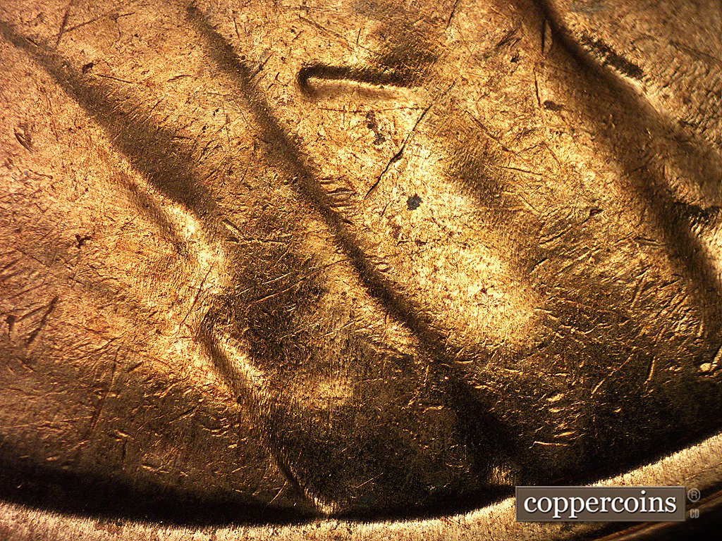 Die-stage C marker on 1960D•1MM•003 showing Die scratches run E-W through the lapel into the coat behind the lapel.