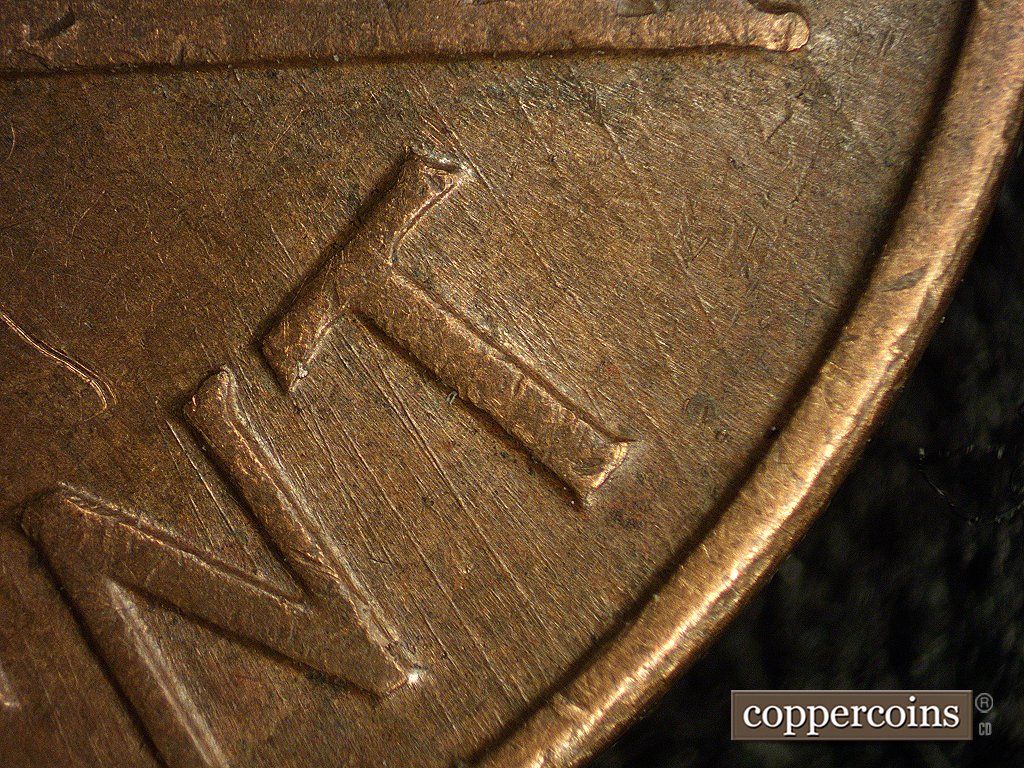 Die-stage A marker on 1960D•1MM•003 showing A few very heavy die scratches show in the T of CENT.