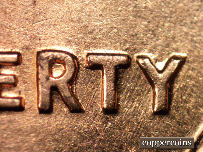 Die-stage B marker on 1960D•1MM•004 showing SW die scratches through RTY in LIBERTY.