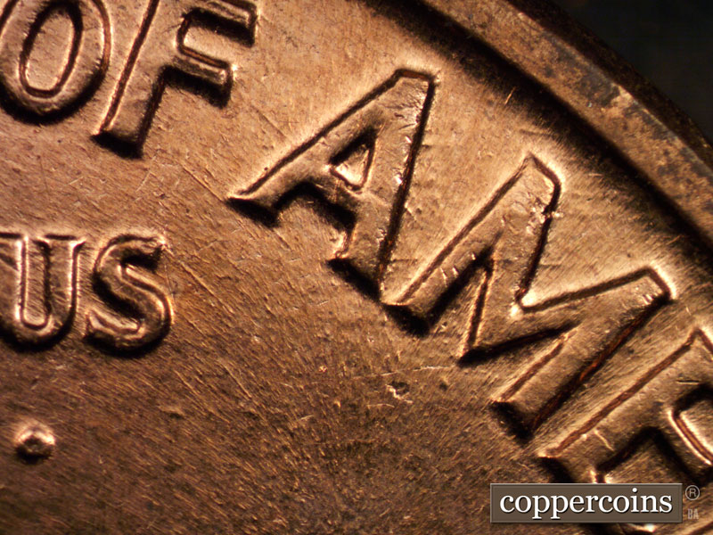 Die-stage B marker on 1960D•1MM•004 showing SE die scratches from F in OF to first A in AMERICA.