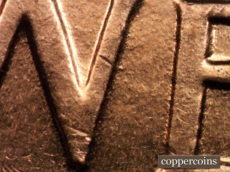 Die-stage B marker on 1960D•1MM•004 showing Die dot next to N in ONE.