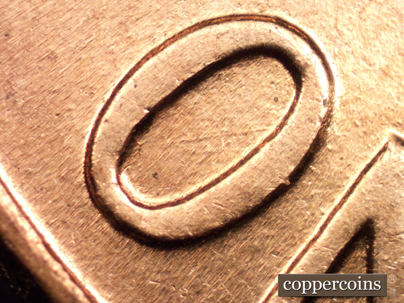 Die-stage B marker on 1960D•1MM•004 showing Die scratch inside O in ONE.