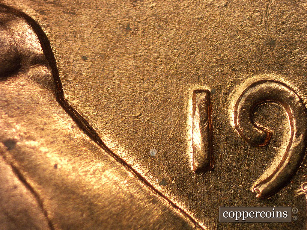 Die-stage A marker on 1960D•1MM•004 showing Small, short die gouge shows to the left of the 1 of the date.