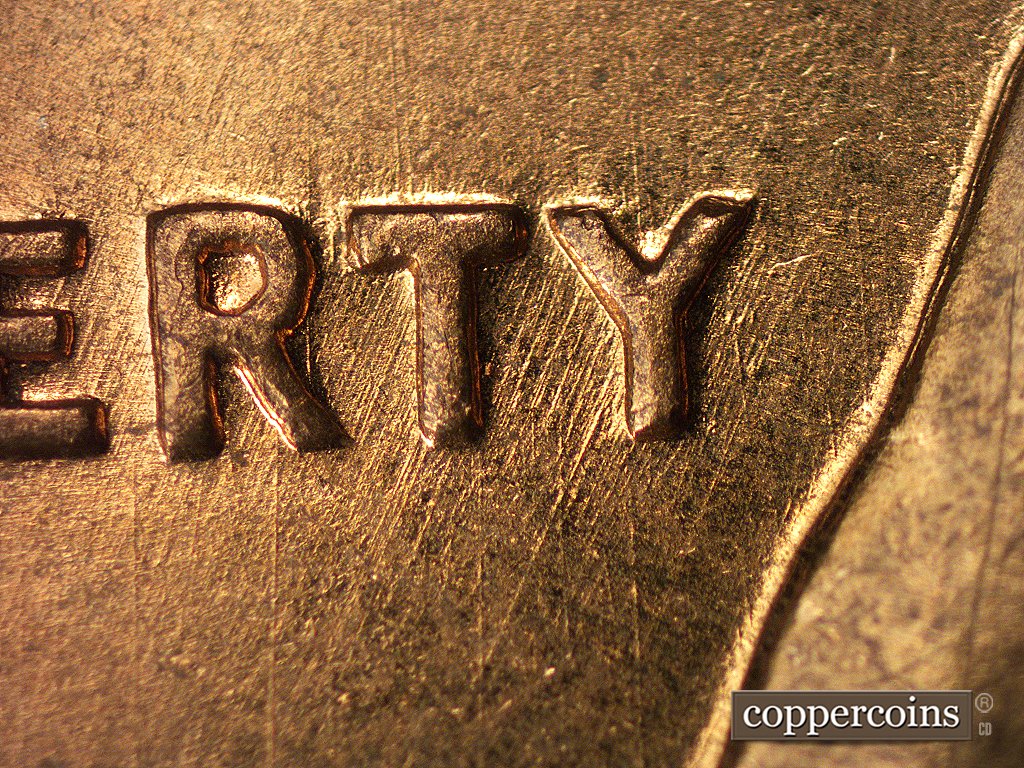 Die-stage A marker on 1960D•1MM•004 showing Thin, sharp die scratches run NE-SW through the RTY of LIBERTY.