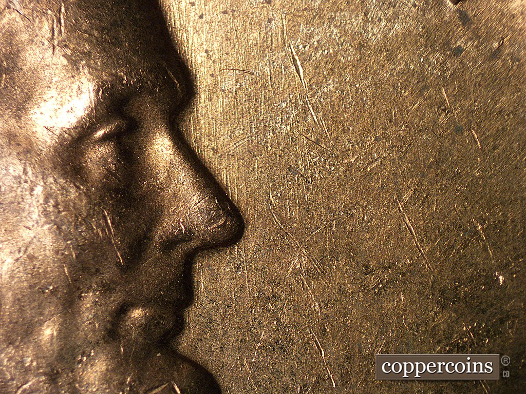 Die-stage A marker on 1960D•1MM•004 showing Die scratches in front of face.