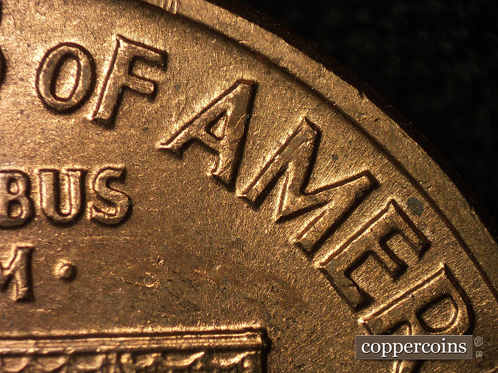 Die-stage A marker on 1960D•1MM•004 showing No die scratches directly around the first A of AMERICA. This develops later in the die's life.