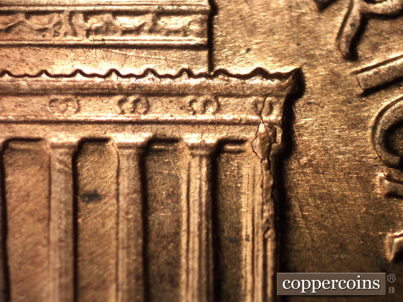Die-stage C marker on 1960D•1MM•005 showing Die chip on right cornice.