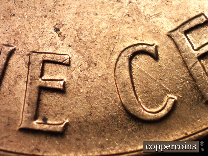 Die-stage C marker on 1960D•1MM•005 showing SE die scratch in C of CENT.