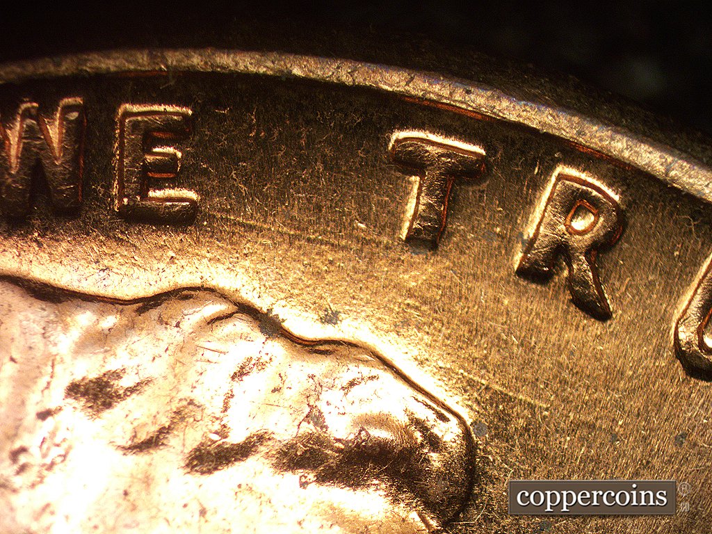 Die-stage B marker on 1960D•1MM•005 showing Die scratches generally E-W above the head.