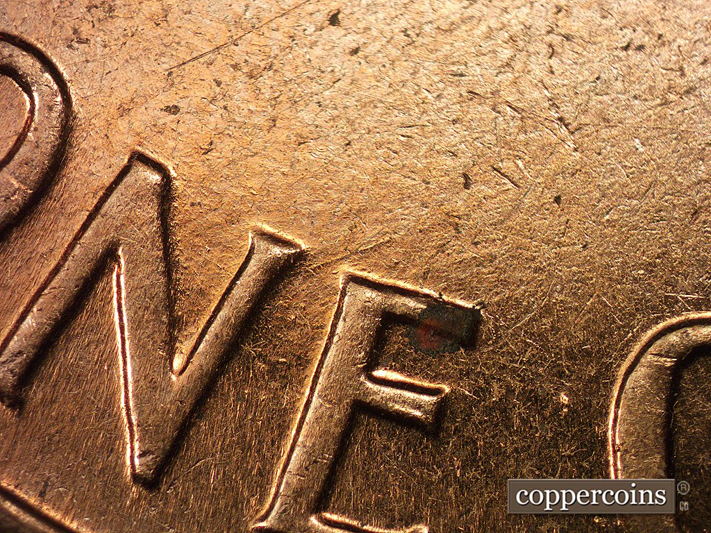 Die-stage B marker on 1960D•1MM•005 showing Die scratches show around NE of ONE.