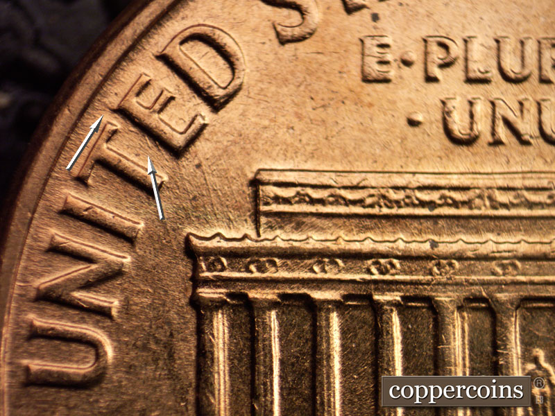 Die-stage B marker on 1960D•1MM•006 showing NW die scratches from left cornice up to E in UNITED, Die gouge from top of E in UNITED.