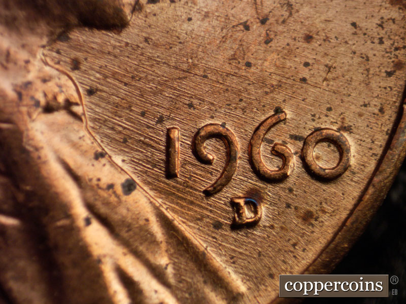 Die-stage D marker on 1960D•1MM•006 showing ESE die scratches from throat and lapel through date.
