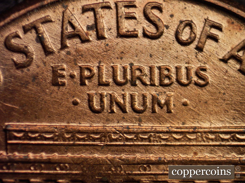 Die-stage D marker on 1960D•1MM•006 showing NW die scratches through E PLURIBUS UNUM.