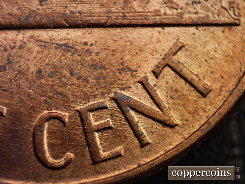 Die-stage D marker on 1960D•1MM•006 showing ESE die scaratches through CENT.