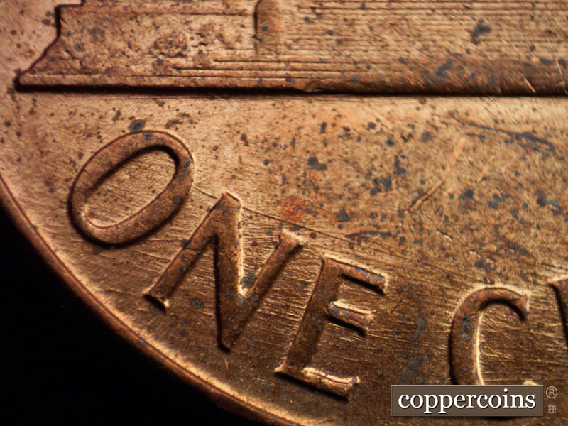 Die-stage D marker on 1960D•1MM•006 showing Generally ESE die scratches through ONE.