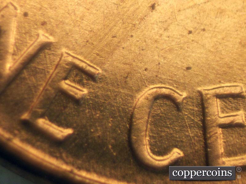 Die-stage B marker on 1960D•1MM•007 showing Intersecting die scratches through E in ONE and C in CENT.