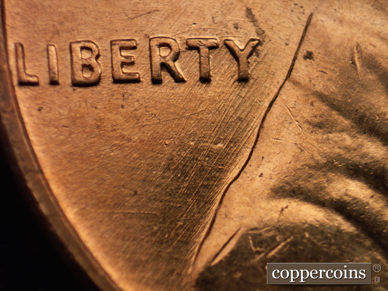 Die-stage B marker on 1960D•1MM•008 showing Multidirectional die scratches under LIBERTY.
