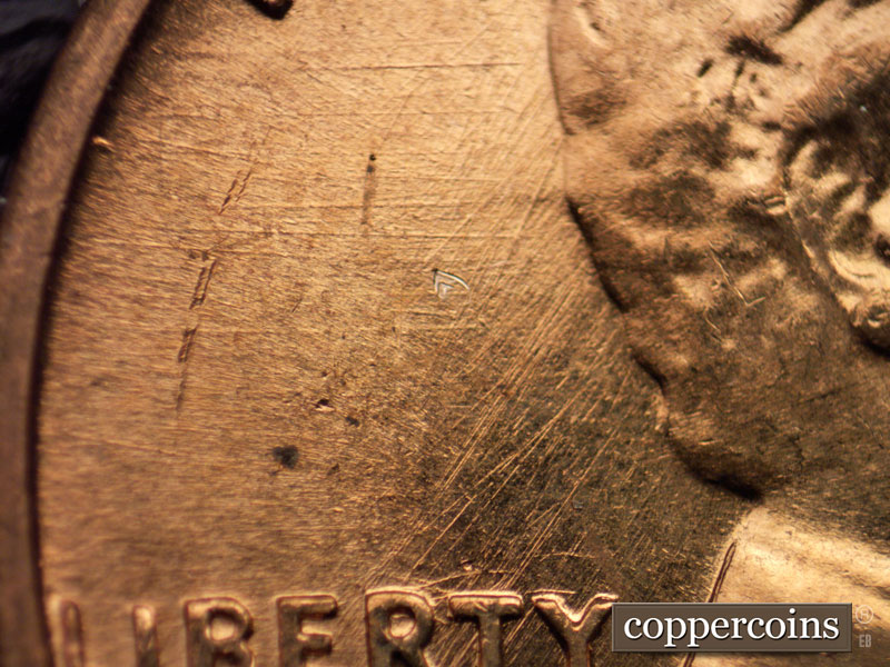 Die-stage B marker on 1960D•1MM•008 showing Multidirectional die scratches above LIBERTY.
