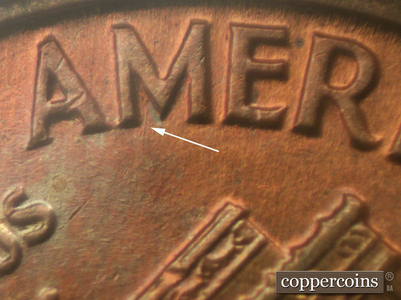 Die-stage B marker on 1960D•1MM•009 showing Die scratch from M in AMERICA.