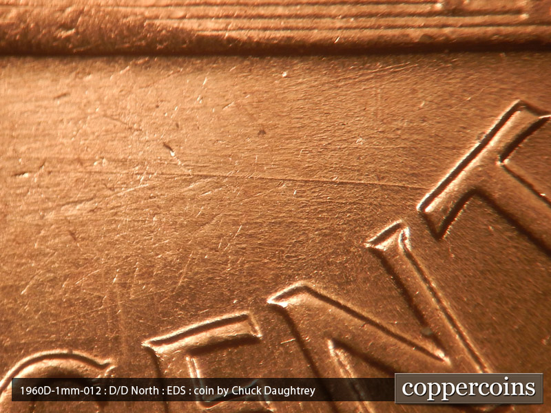 Die-stage A marker on 1960D•1MM•012 showing WNW die scratches above CENT.